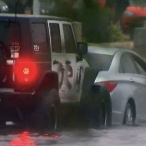 CHAMPION DRIVER USES JEEP TO RESCUE FLOODED CARS